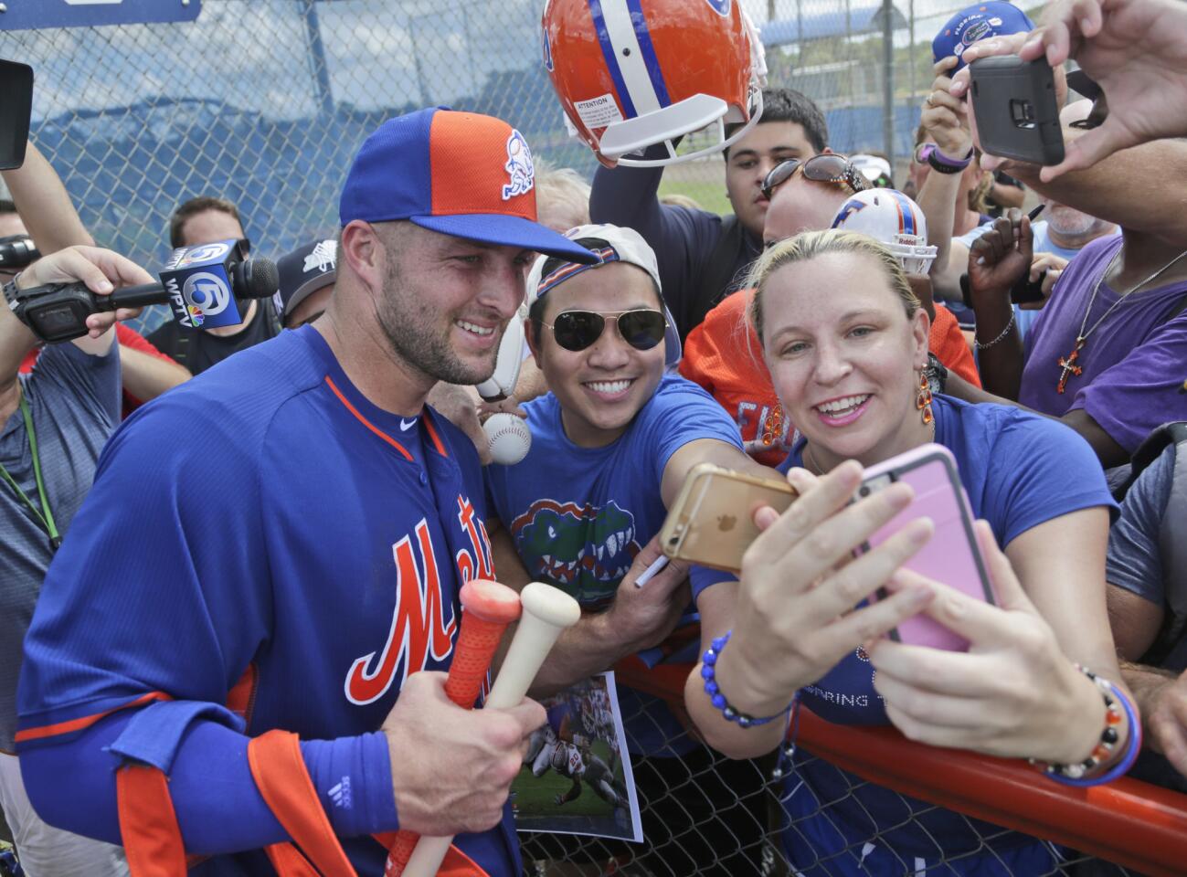 Tim Tebow takes a selfie with fans at the New York Mets' complex, Monday, Sept. 19, 2016, in Port St. Lucie, Fla. The 2007 Heisman Trophy winner and former NFL quarterback got to the complex early Monday, and started his first workout as part of their instructional league team. (AP Photo/Wilfredo Lee)