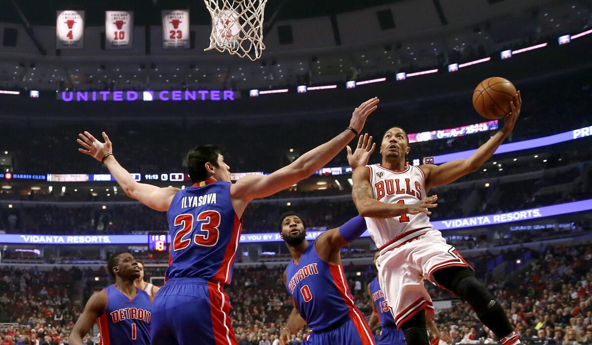 Chicago Bulls guard Derrick Rose (1) shoots as Detroit Pistons guard Reggie Jackson (1), Ersan Ilyasova (23) and Andre Drummond (0) defend during the first half on Friday.