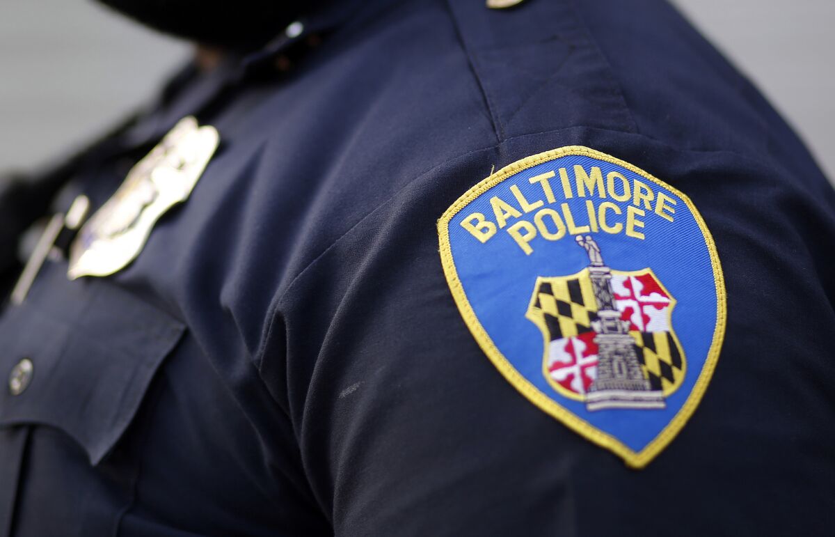 FILE - A shoulder patch is displayed on a Baltimore Police Department officer on March 31, 2016, in Baltimore. Two veteran Baltimore police officers are facing criminal indictments stemming from separate and unrelated allegations, city officials said Thursday, March 16, 2023. One officer is accused of sexual harassment and the other allegedly got drunk and belligerent at a Baltimore bar, assaulted two women and pulled a gun while refusing to pay his tab. (AP Photo/Patrick Semansky, File)