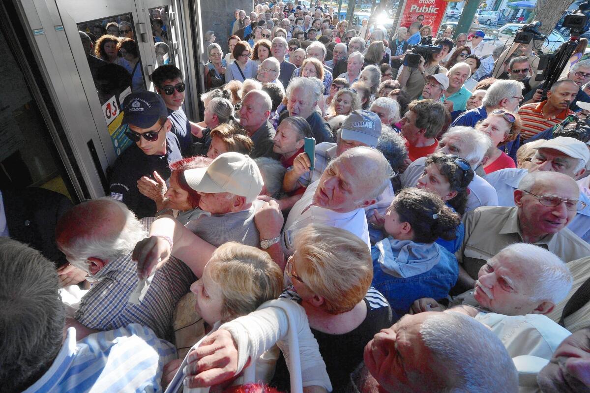 Pensioners mass outside a bank in Athens. Designated banks opened their doors to let retirees draw about $130 a week in benefits. Greeks are limited to $66 a day in ATM withdrawals.