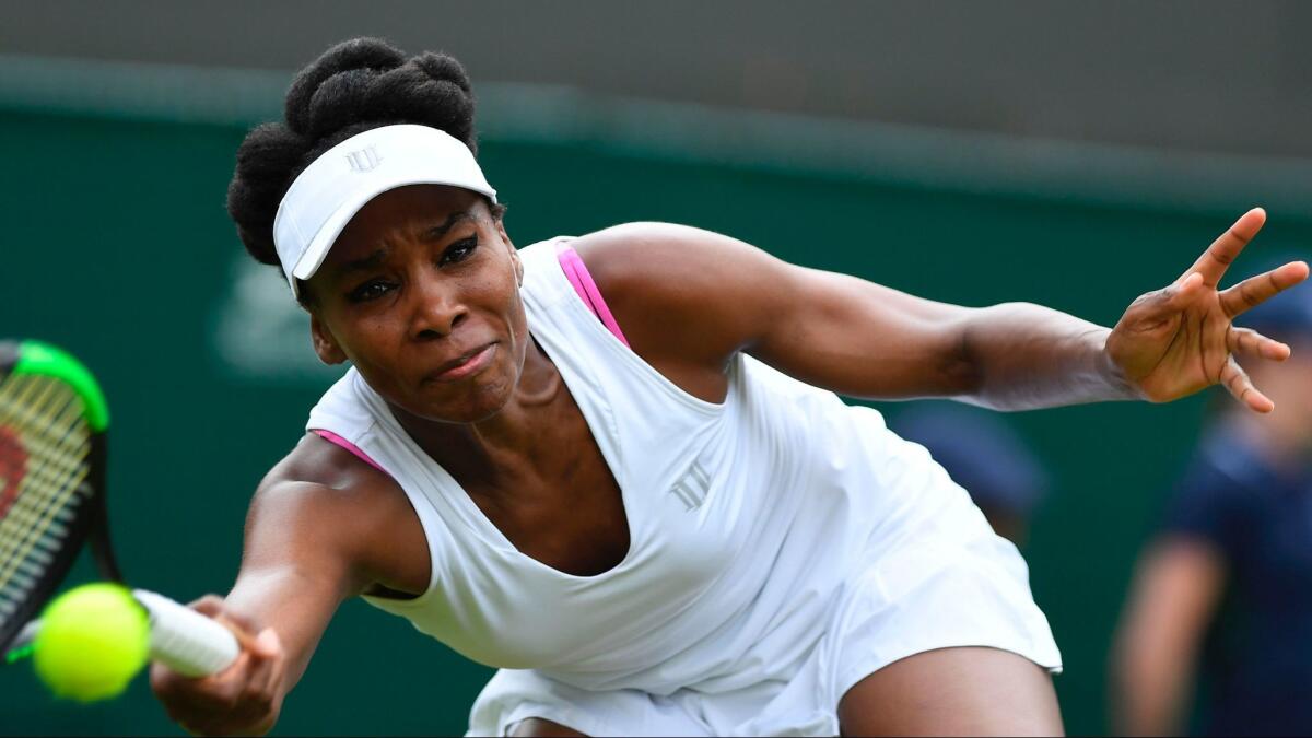 Venus Williams returns a shot from Elise Mertens during the first round of Wimbledon on Monday.