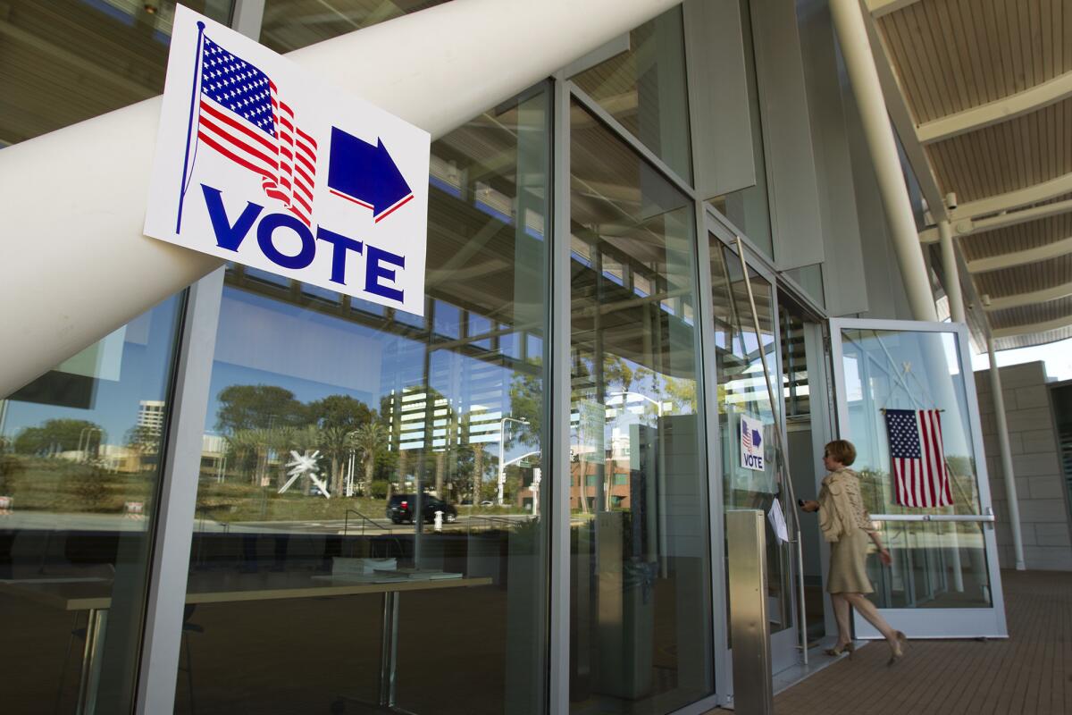 A voter walks into a polling station at the Newport Beach Civic Center community room on Election Day in November 2014.