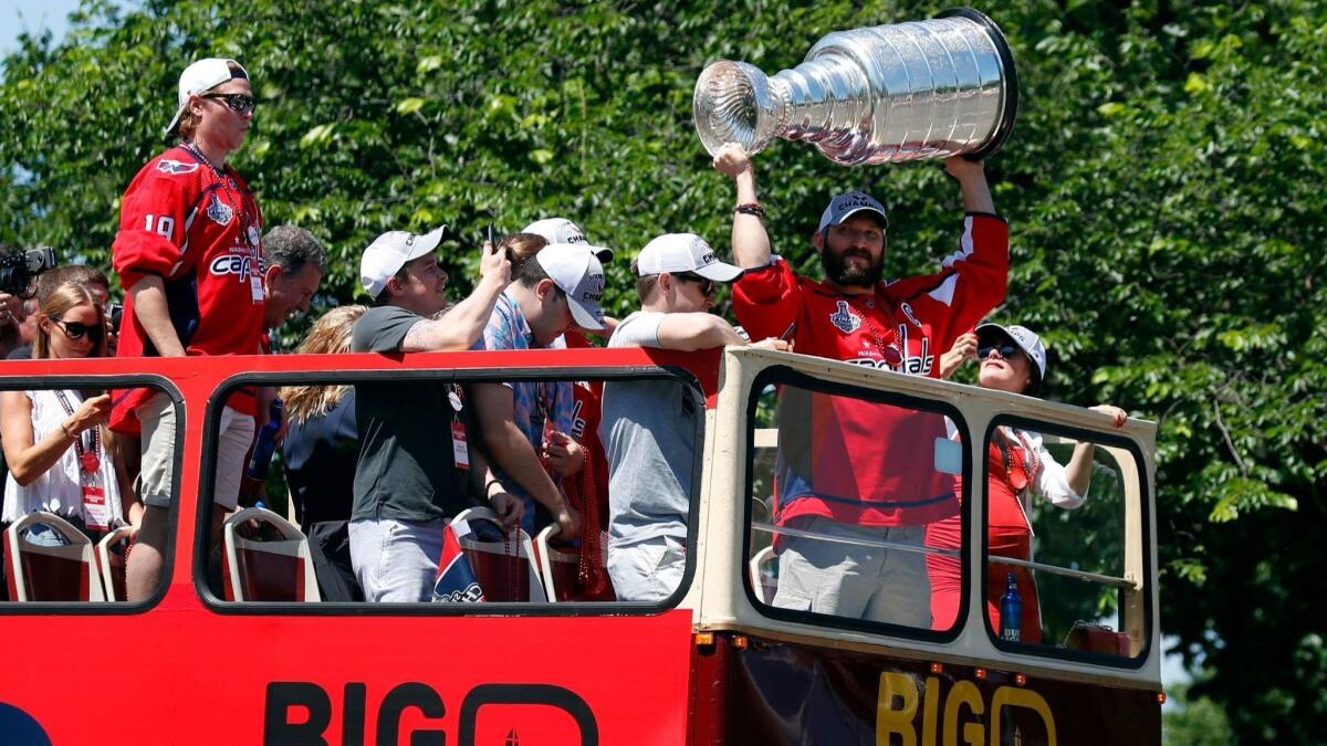 Washington Capitals captain Alex Ovechkin lifts the Stanley Cup during a victory parade in Washington on Tuesday.