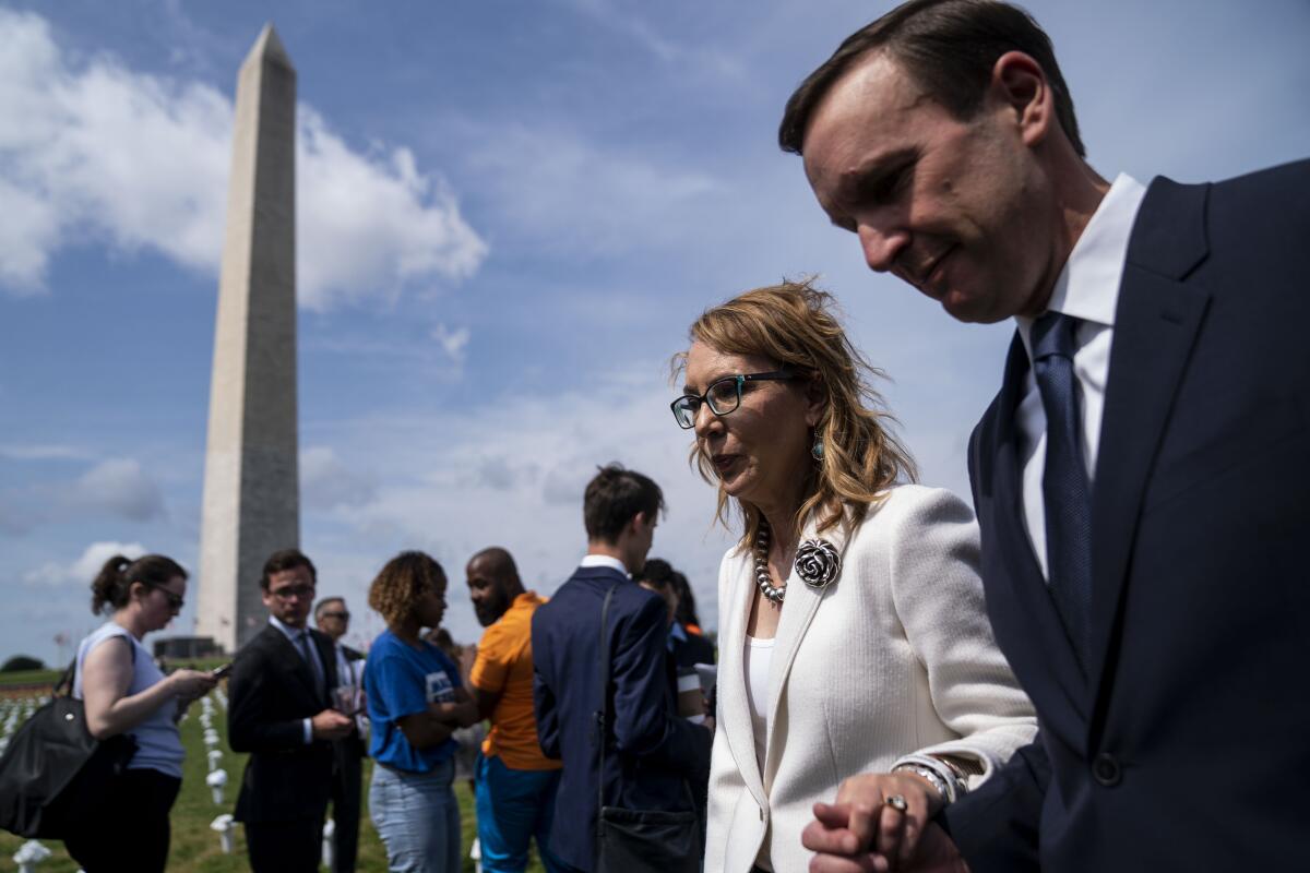 Rep. Gabrielle Giffords walks with Sen. Chris Murphy