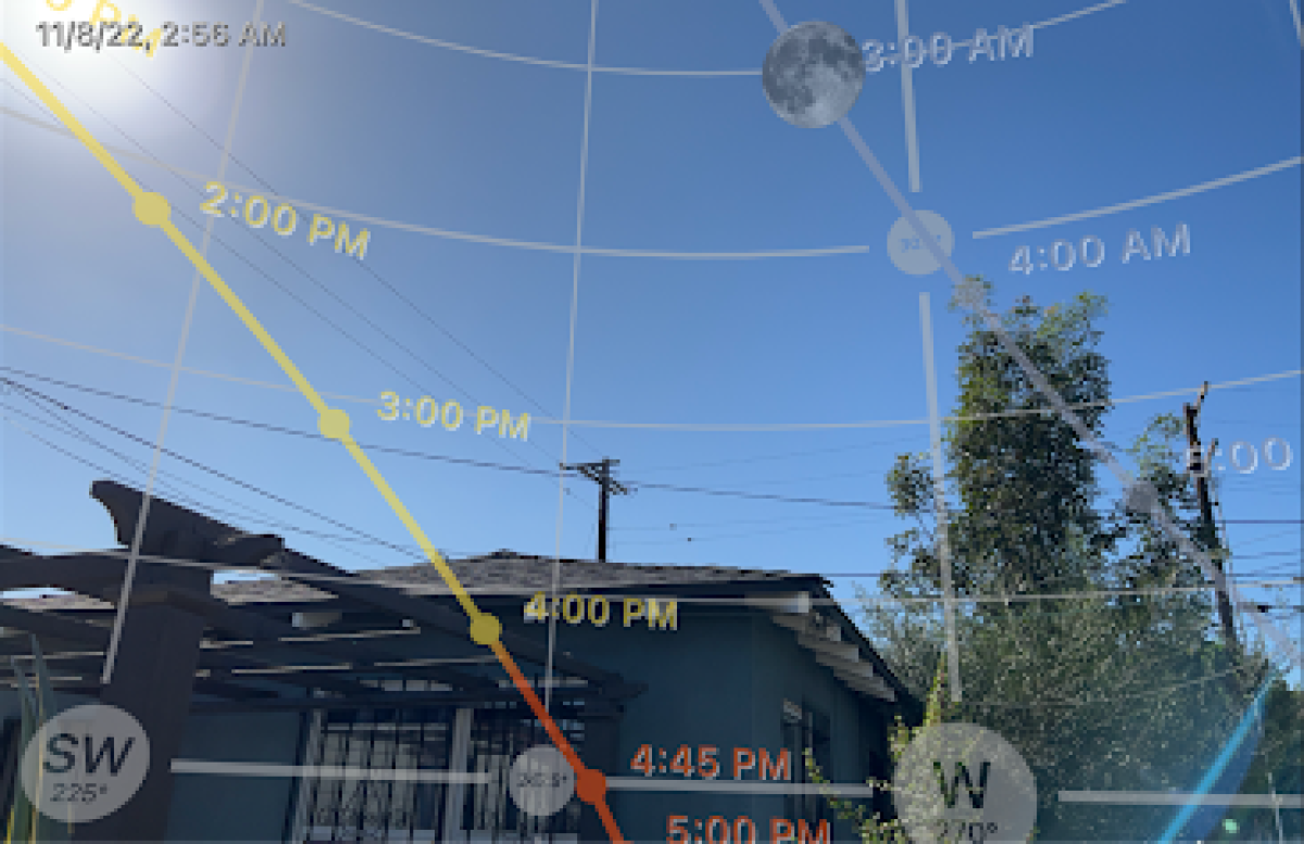 The PhotoPills app shows an Augmented Reality view of the path of the sun and moon for the selected date.