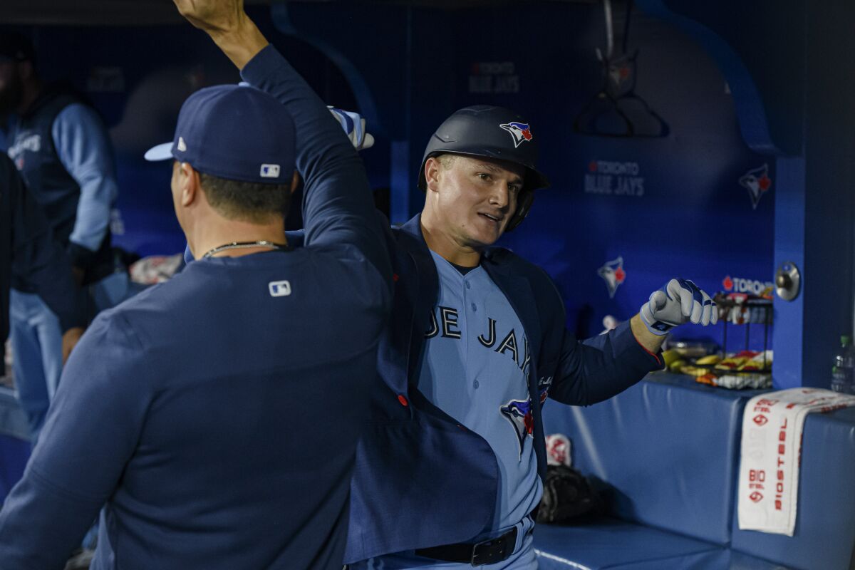 Toronto Blue Jays' Matt Chapman, right, is congratulated after his home run against the New York Yankees during the second inning of a baseball game Wednesday, May 4, 2022, in Toronto. (Christopher Katsarov/The Canadian Press via AP)