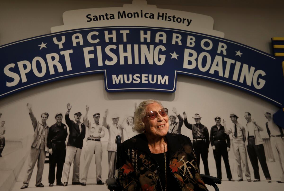 Florence Kinney sits in front of an exhibit at the Santa Monica History Museum