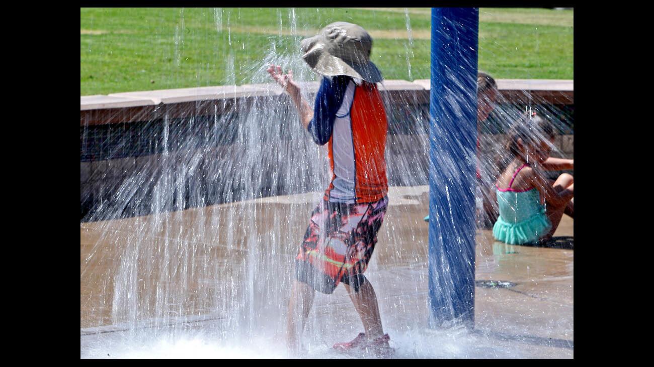 Collin Bagnis, 6 of Pasadena, enjoys the water features at Cerritos Park, in Glendale on Wednesday, July 25, 2018. With temperatures rising, parents look for places to keep their kids cool while having fun.