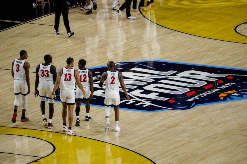 San Diego State basketball players walk back to the bench during their Final Four win over FAU.