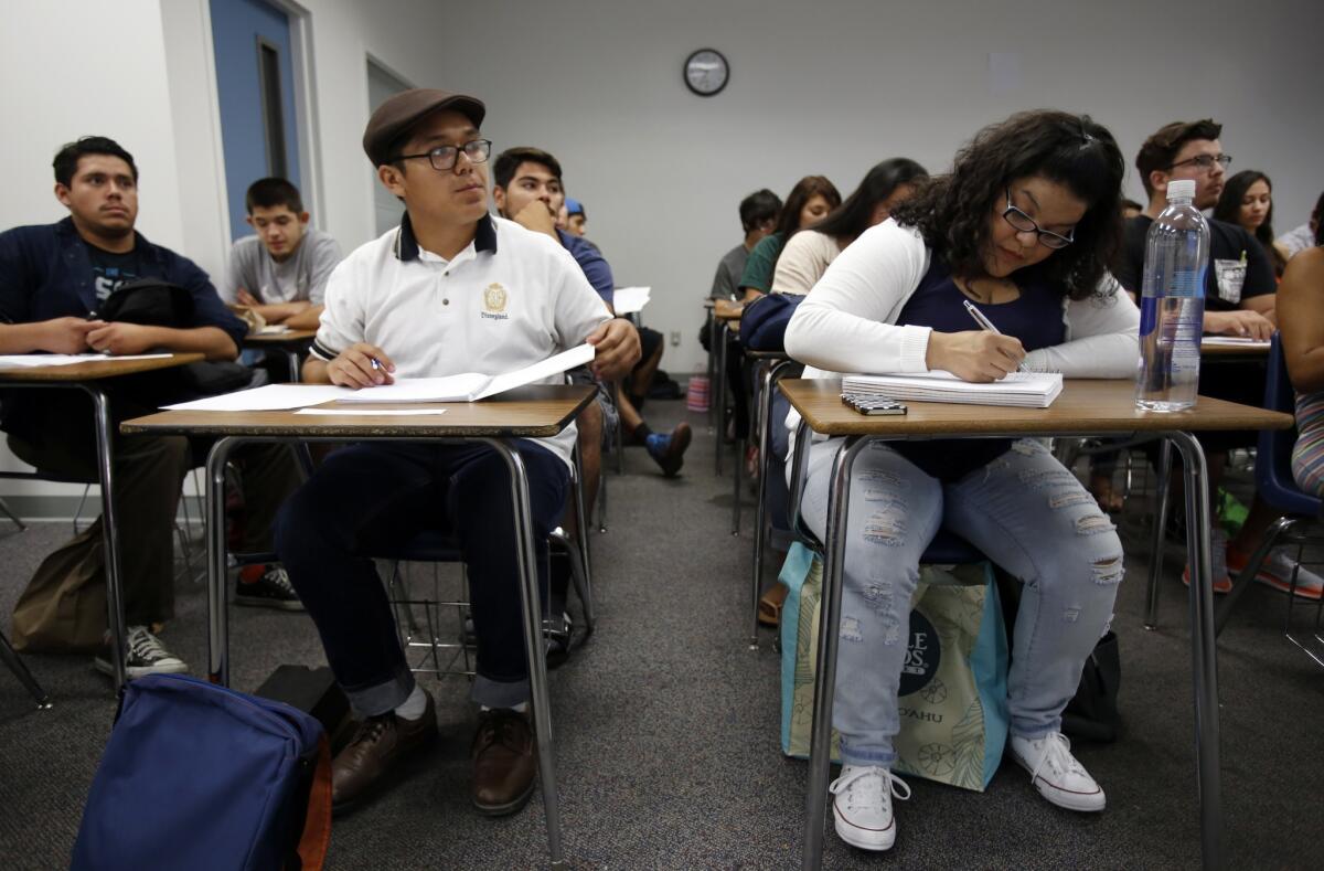 Apolo Ayala, 18, left, and Tiffany Guerra, 32, take notes during a class at Rio Hondo College in Whittier, as part of the new Pathways to Law School initiative that aims to connect more California community college students to law schools in the state.