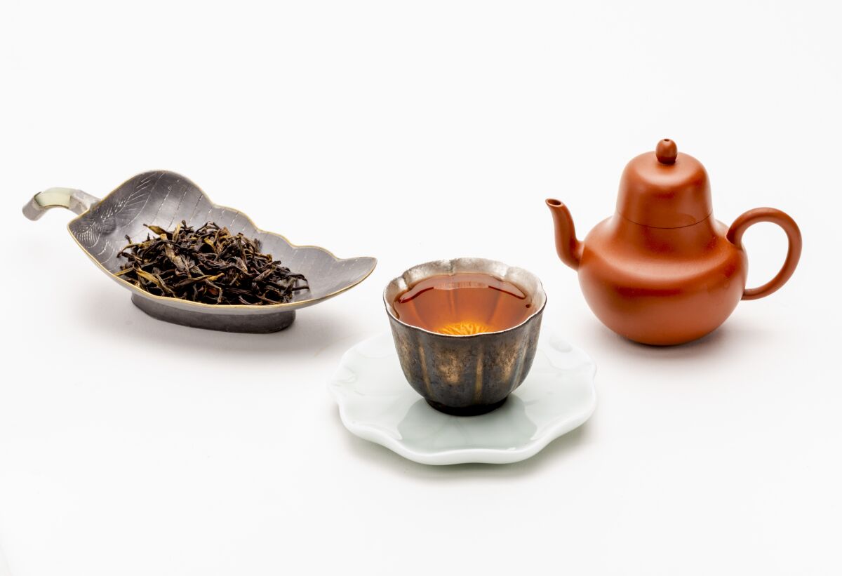 Tea leaves, tea and a handmade teapot