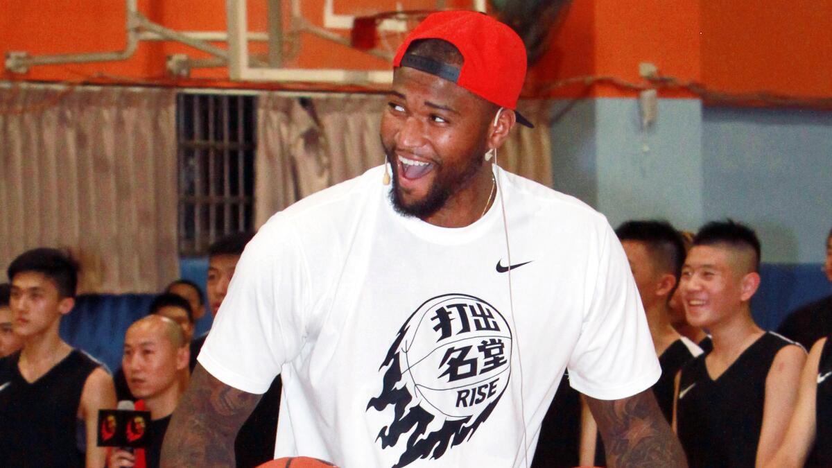 Sacramento Kings center DeMarcus Cousins laughs while hosting a basketball camp in Taipei, Taiwan, on June 8.