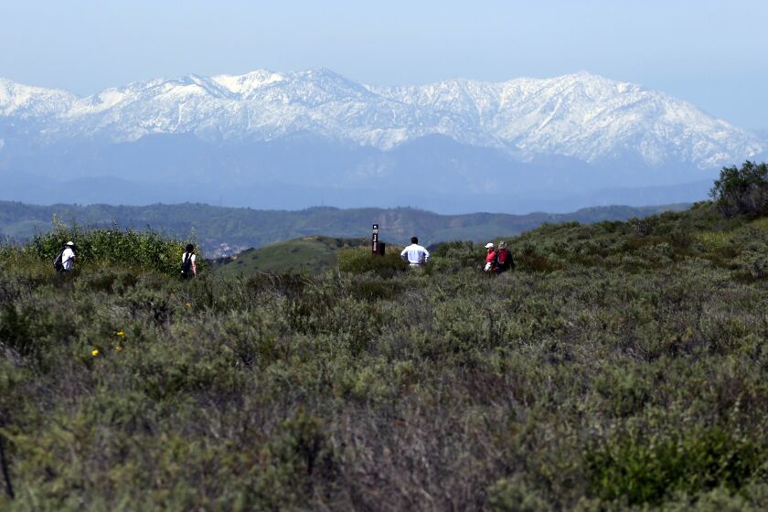 Hikers enjoy the panoramic view of the San Bernardino Mountains in the Saddleback Wilderness trail located in OC Parks' Irvine Ranch Open Space on Monday, March 27, 2023. The 3.3 mile hiking, biking, and equestrian trails with views of the mountains will be open to the public on April 1. (Photo by James Carbone)