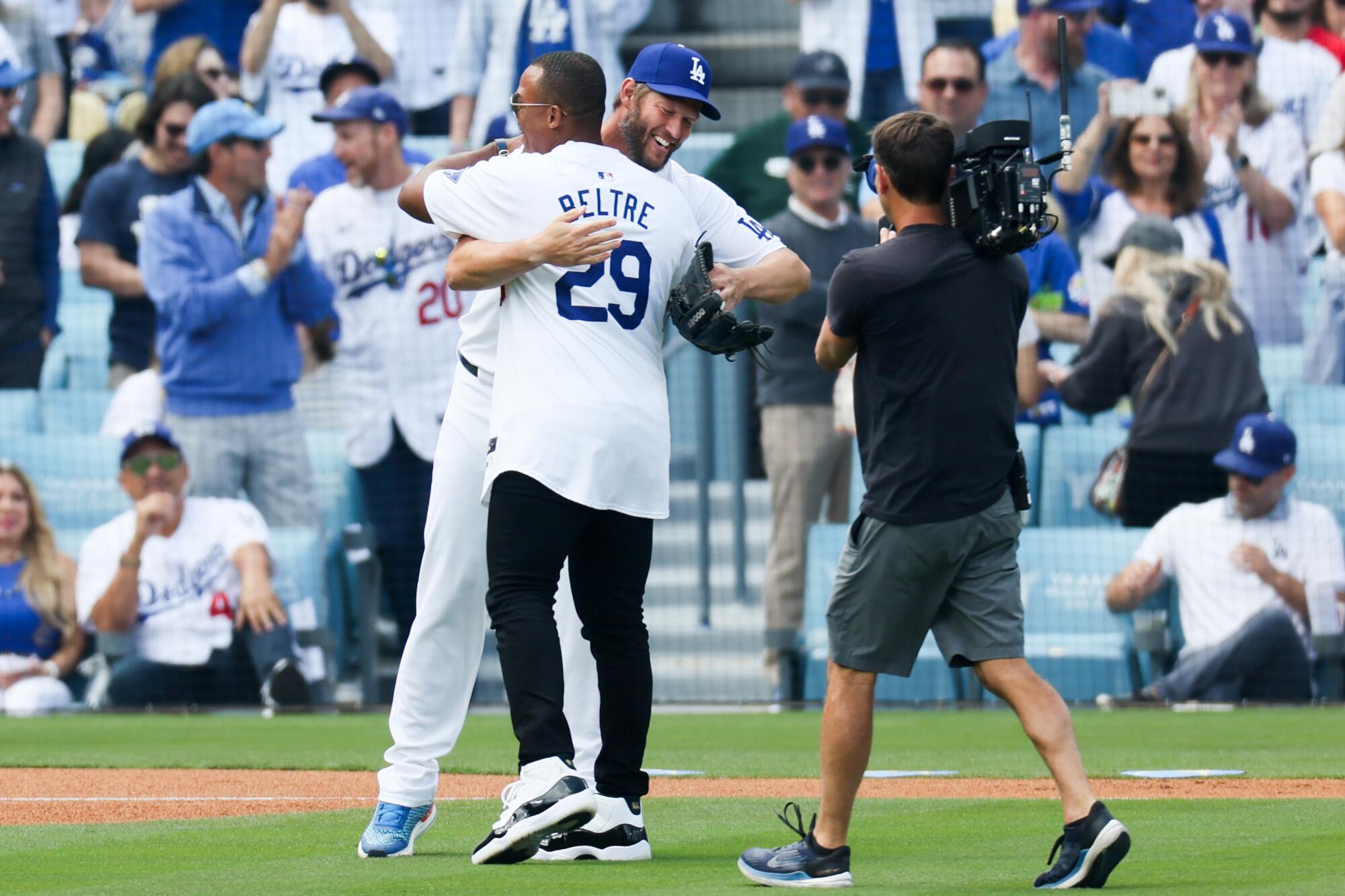 Former Los Angeles Dodgers Adrian Beltre embraces pitcher Clayton Kershaw.