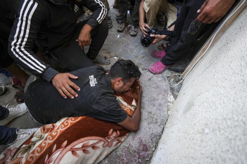 Palestinian mourns a relative killed in the Israeli bombardment of the Gaza Strip outside a hospital in Deir al Balah on Tuesday, June 4, 2024. (AP Photo/Abdel Kareem Hana)