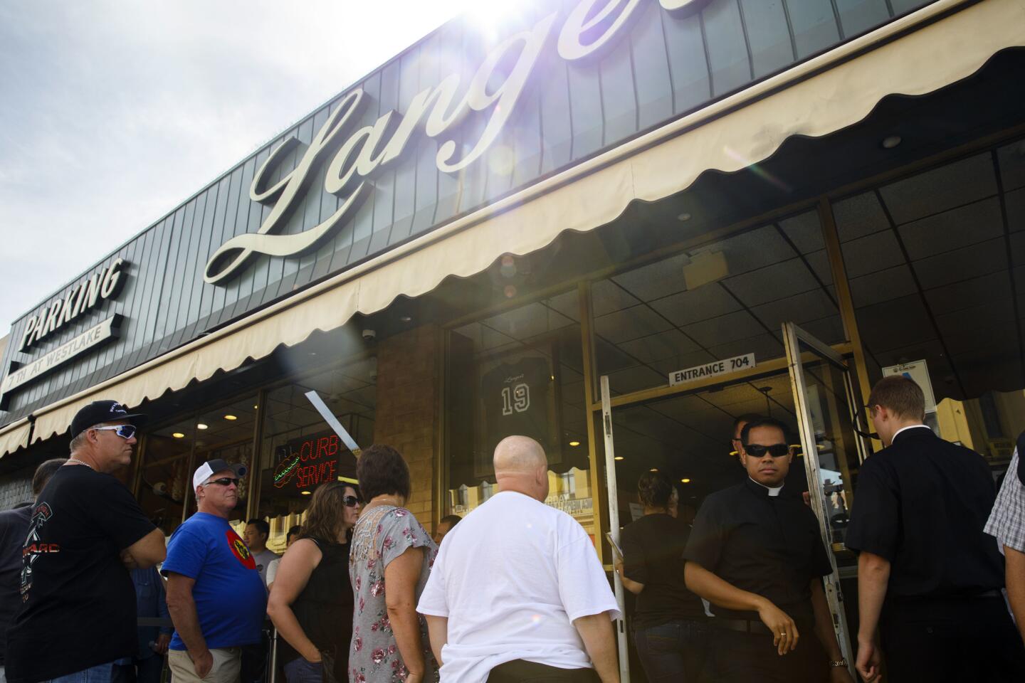 People wait in line at Langer's Deli in 2016.