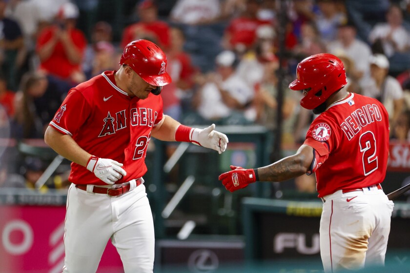 Mike Trout is congratulated by Angels teammate Luis Rengifo.