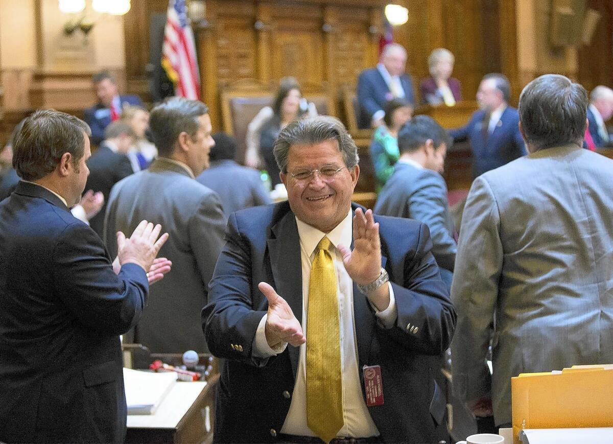Georgia state Rep. Alan Powell celebrates after a gun bill passed in the House this month. Gov. Nathan Deal is expected to sign it into law.