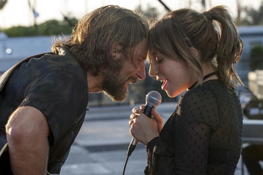 This image released by Warner Bros. shows Bradley Cooper, left, and Lady Gaga in a scene from the latest reboot of the film, "A Star is Born." (Neal Preston/Warner Bros. via AP)