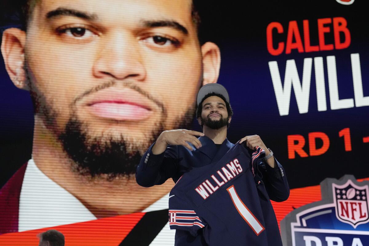 Caleb Williams celebrates after being chosen by the Chicago Bears with the first pick of the NFL draft.