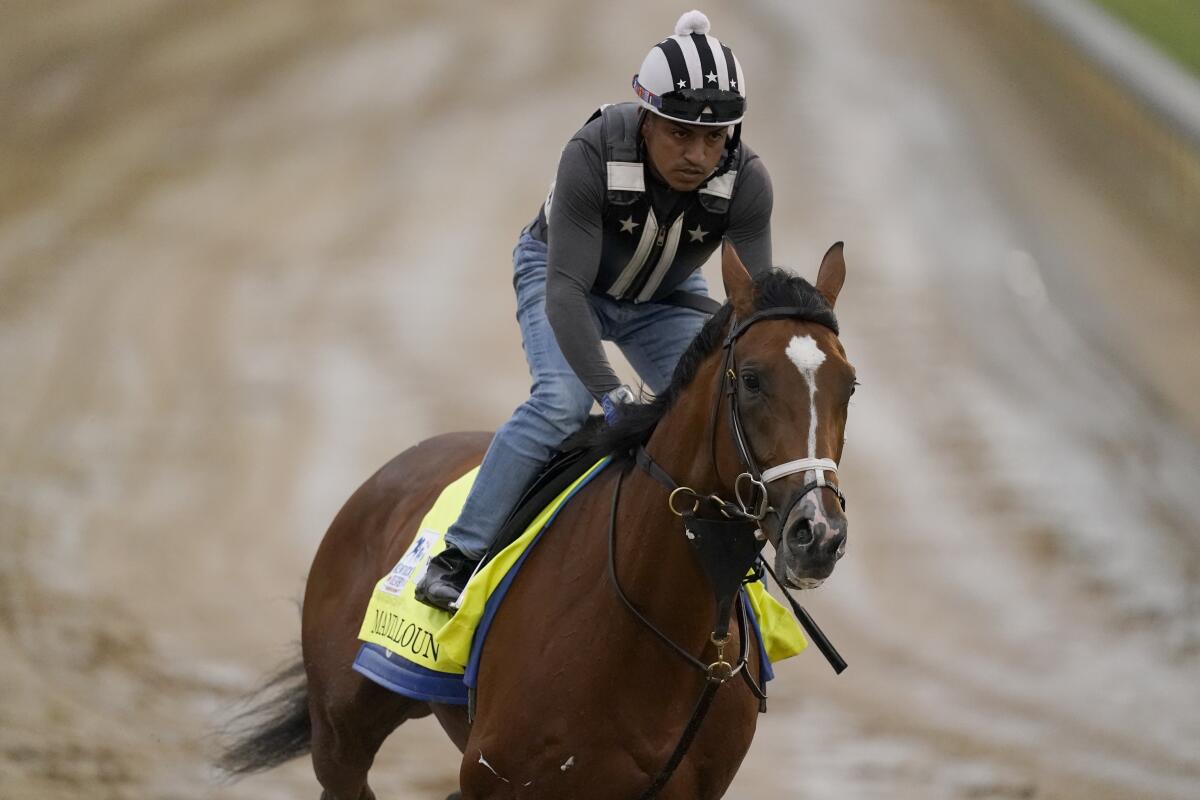 Kentucky Derby entrant Mandaloun works out at Churchill Downs Thursday, April 29, 2021, in Louisville, Ky. The 147th running of the Kentucky Derby is scheduled for Saturday, May 1. (AP Photo/Charlie Riedel)