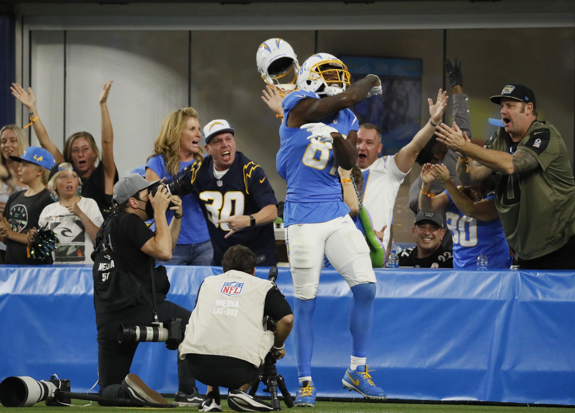 Chargers wide receiver Mike Williams celebrates with fans after scoring a 53-yard touchdown pass.