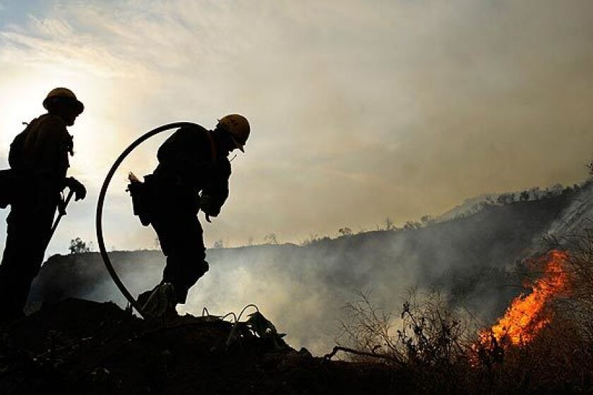 U.S. Forest Service firefighters battle the Station fire along Angeles Crest Highway in La Cañada Flintridge.