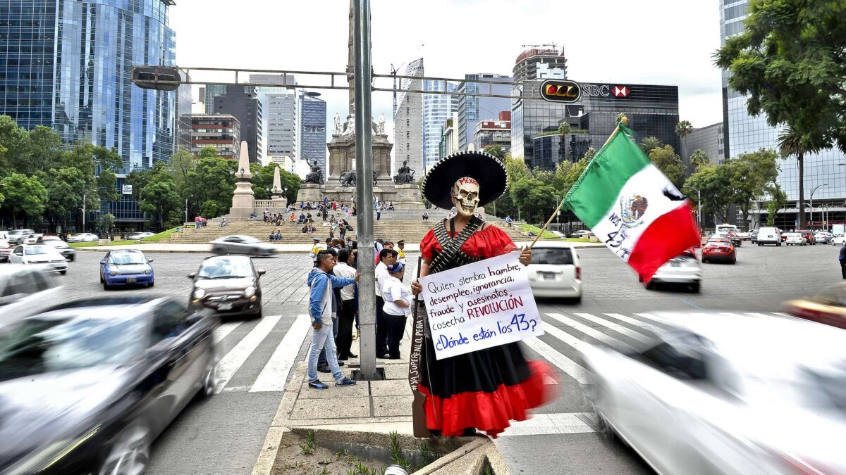 Mexican Revolution-era garb is frequently used as symbol of protest, such as this figure, in Mexico City, dressed as a soldadera, one of the Revolution's female soldiers. Her sign reads: "He who sows hunger, unemployment, ignorance, fraud and murders, harvests Revolution. Where are the 43?"