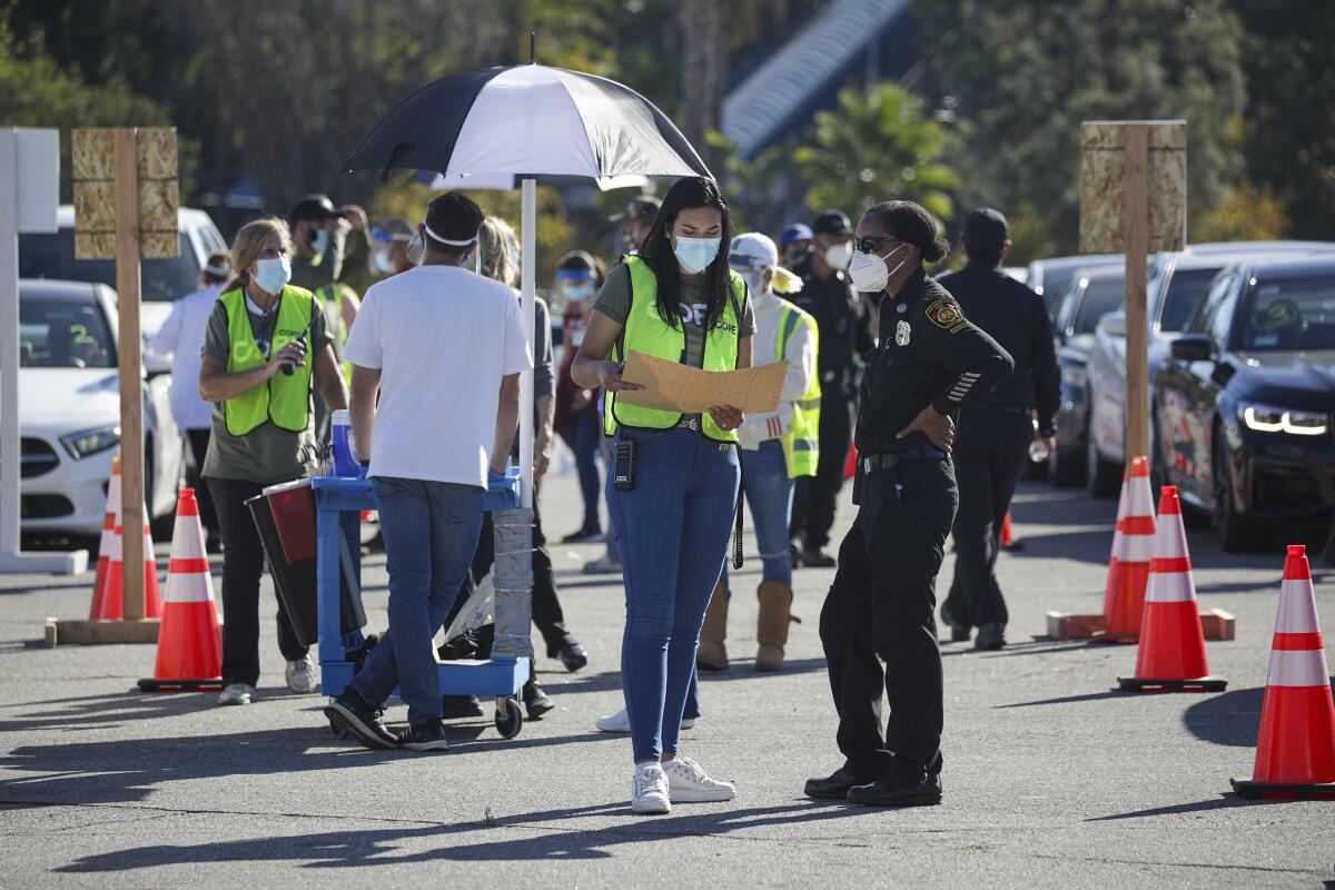 COVID-19 vaccination of healthcare workers takes place in Dodger Stadium parking lot.