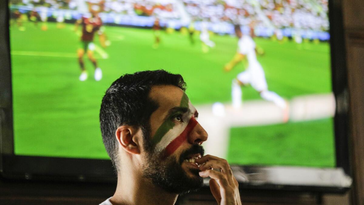 Shahrad Moobed anxiously watches Friday's Iran-Morocco World Cup game.