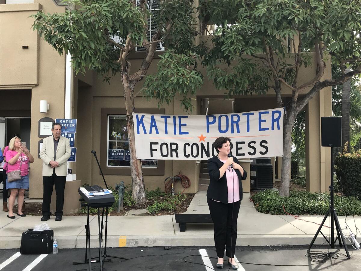 Democratic candidate Katie Porter speaks to volunteers in Mission Viejo. Jon Bauman, Bowzer from the band Sha Na Na, is in the background.