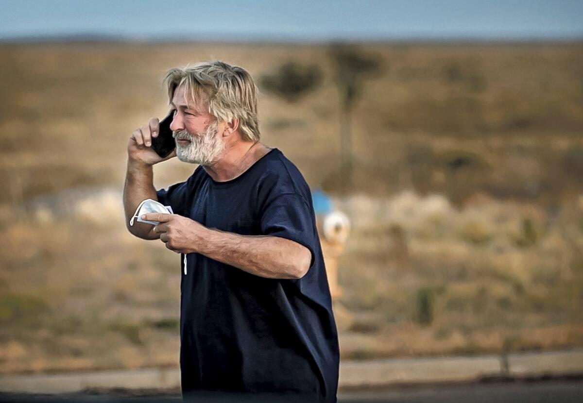 Alec Baldwin speaks on the phone.