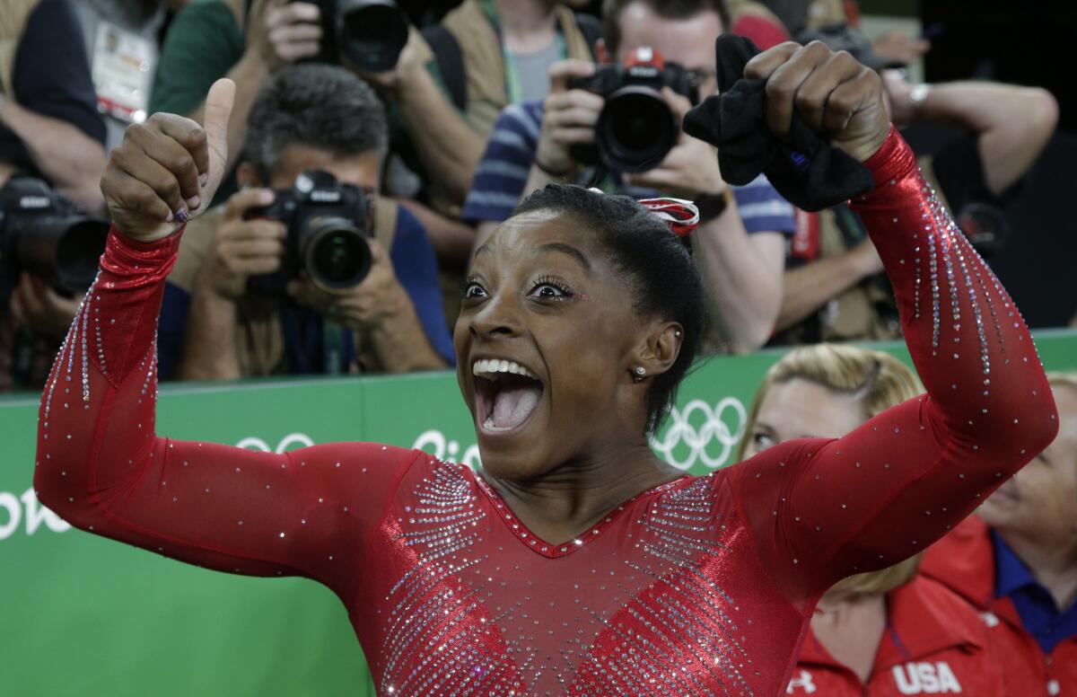 Simone Biles reacts after winning the gold in vault.