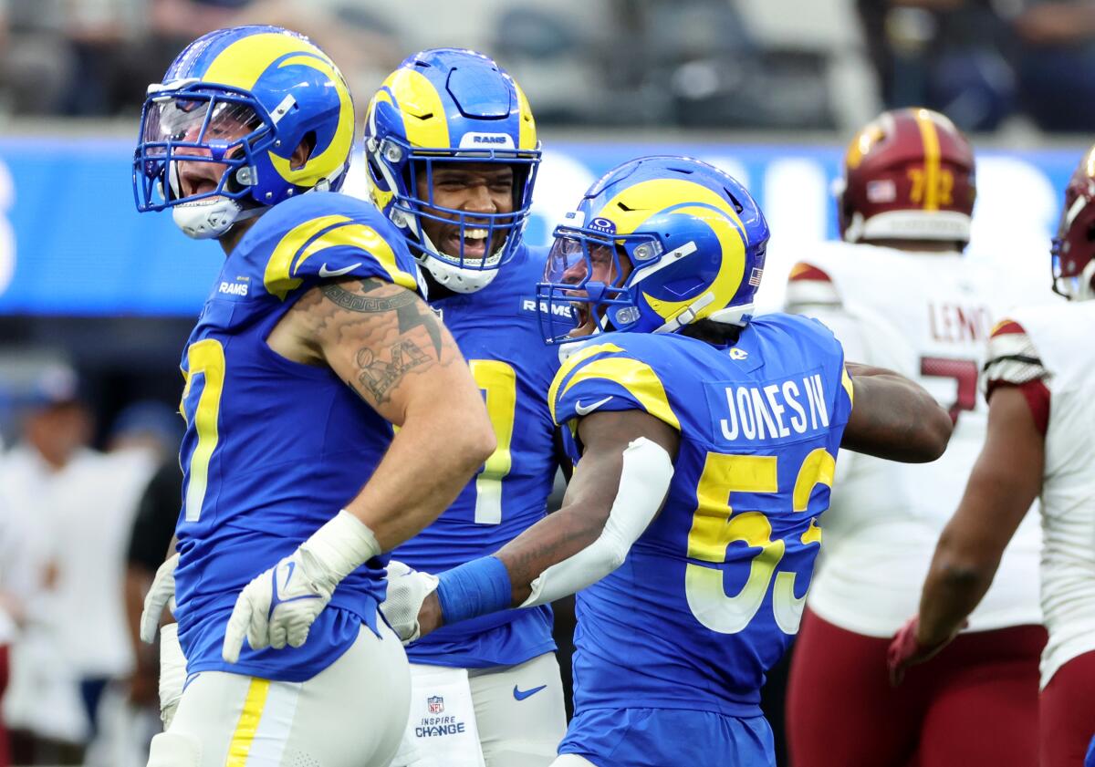 Rams linebacker Ernest Jones IV (53) celebrates a sack with teammates Michael Hecht, left, and Kobe Turner.