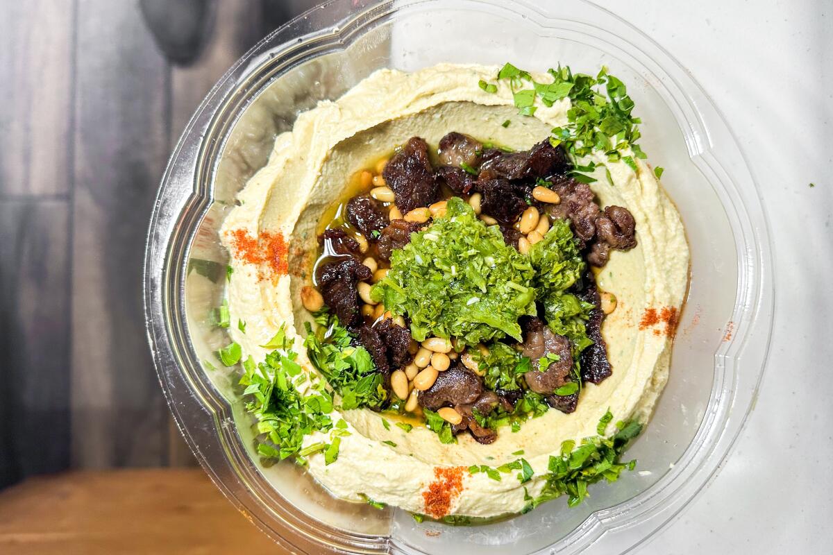 Hummus bil lahme (garnished with fried ribeye and pine nuts) is on the menu at Salam Falafel in Koreatown.