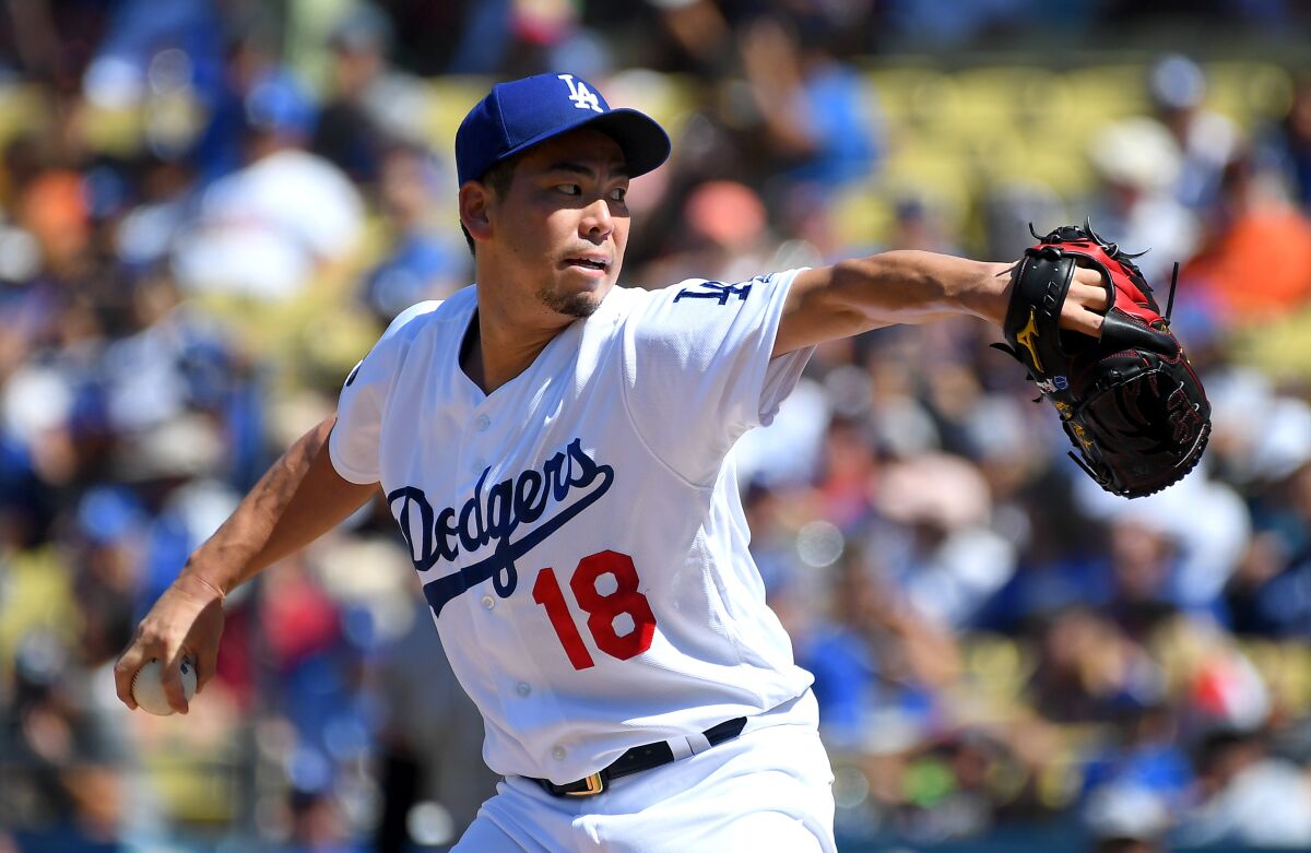 Dodgers reliever Kenta Maeda delivers against the Giants.