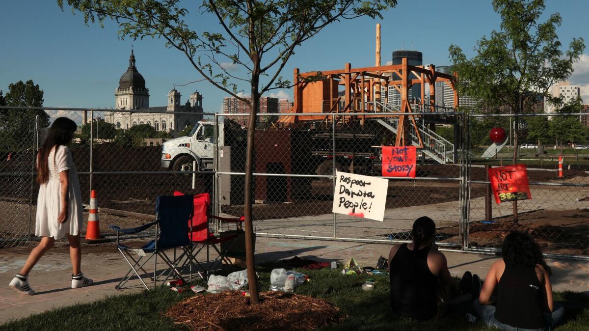 Protesters stand outside the Minneapolis Sculpture Garden, the site of Sam Durant's "Scaffold," in late May. (Anthony Souffle / Star Tribune)