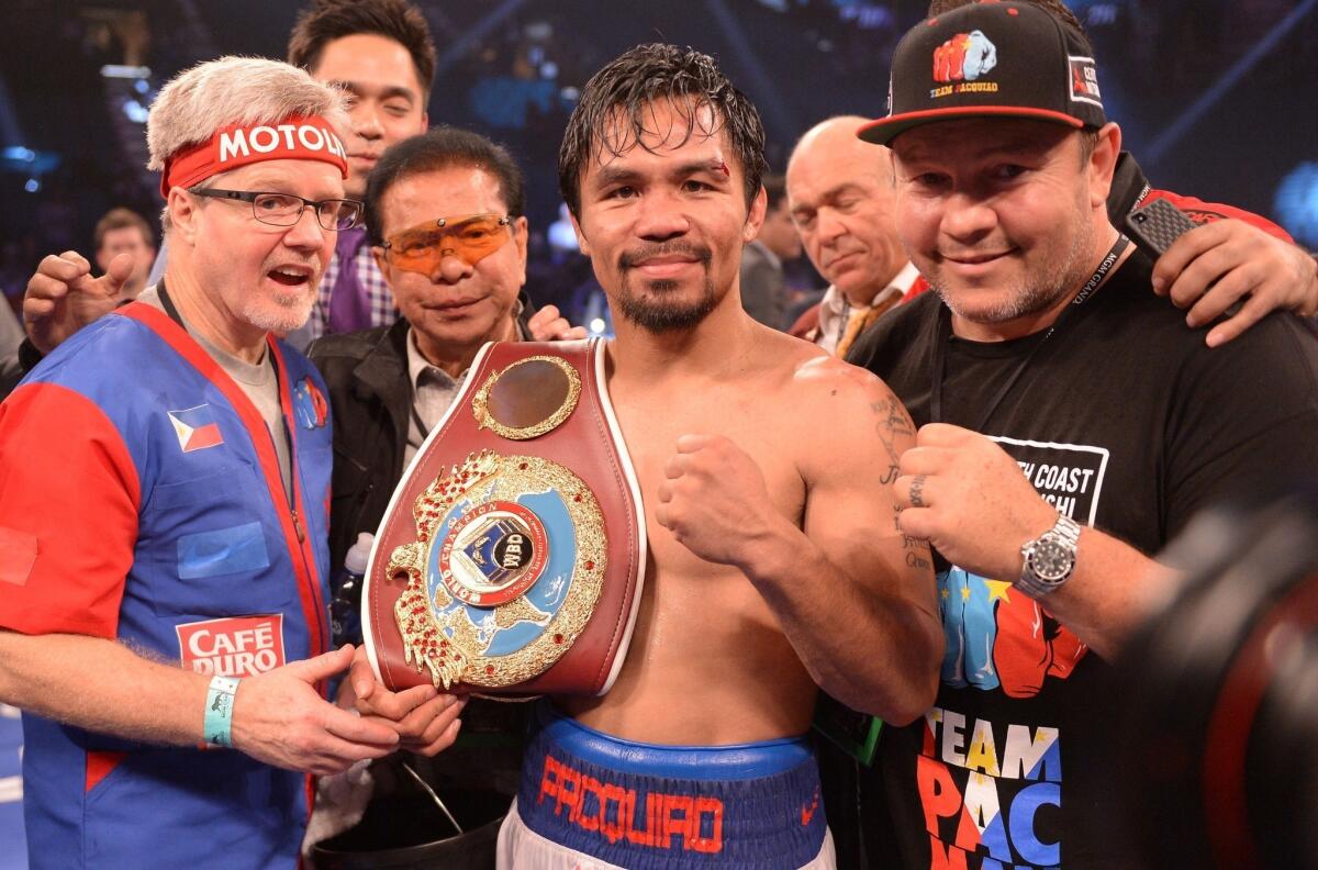 Manny Pacquiao shows off the WBO welterweight belt he won by defeating Timothy Bradley by unanimous decision.
