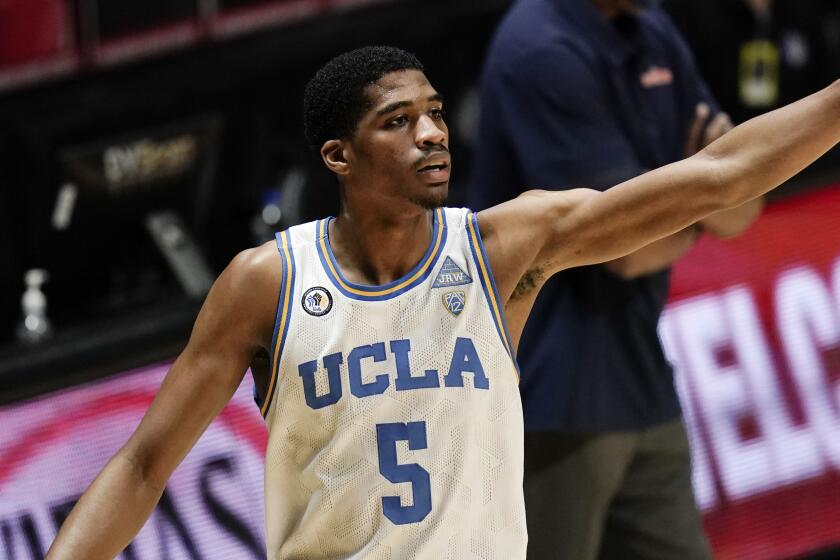 UCLA guard Chris Smith gestures during the first half of an NCAA college basketball game against Pepperdine.