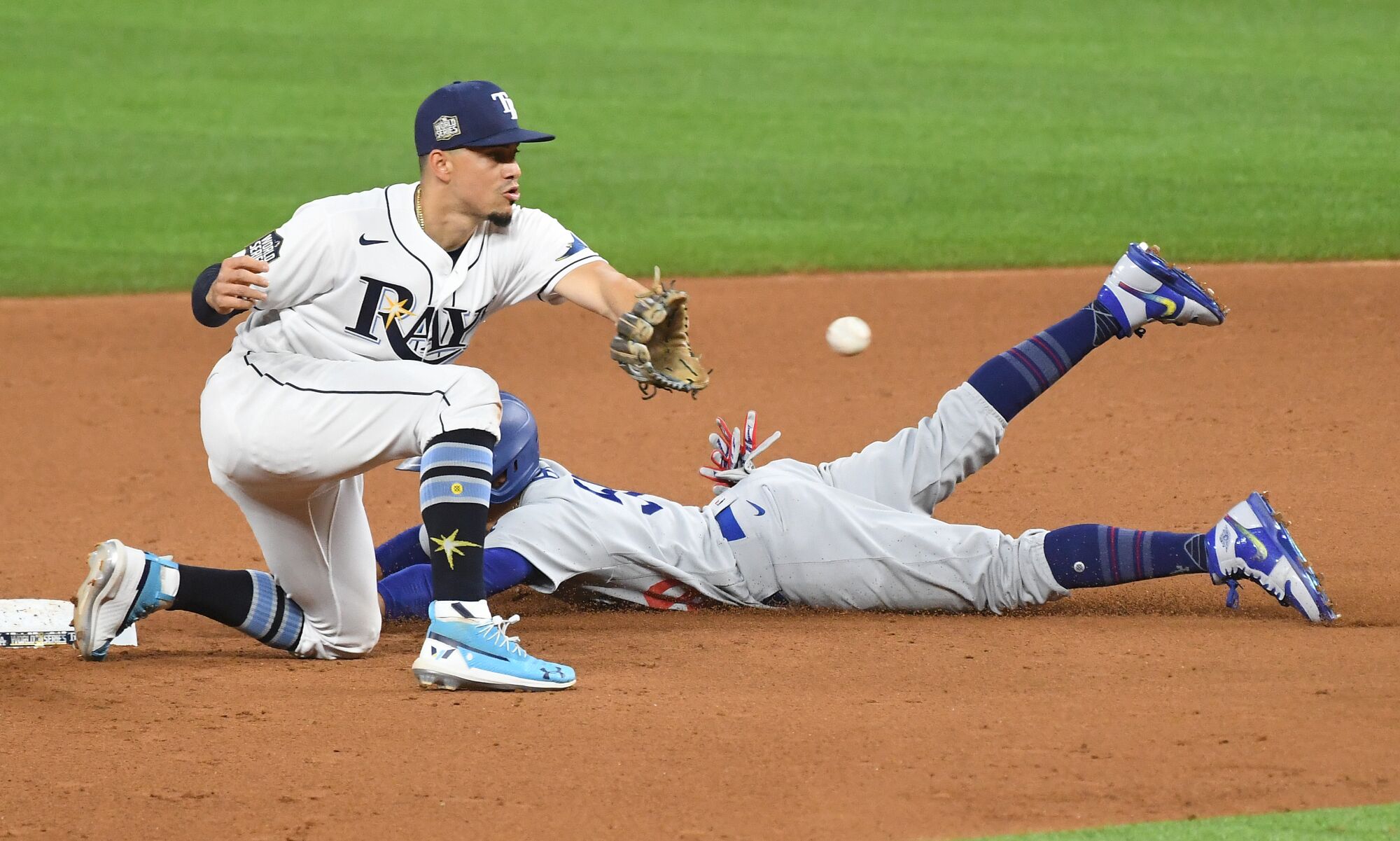 Dodgers baserunner Mookie Betts steals second base in front of Rays shortstop Willy Adames