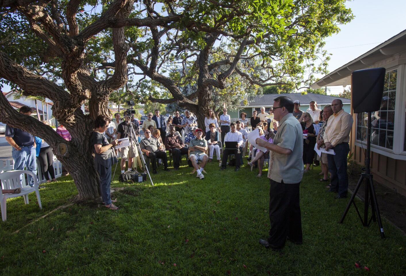 Costa Mesa Mayor Jim Righeimer talks to homeowners and members of the community at Carrie Renfro's Eastside home on Thursday about the issue of rehabilitation homes in Costa Mesa.