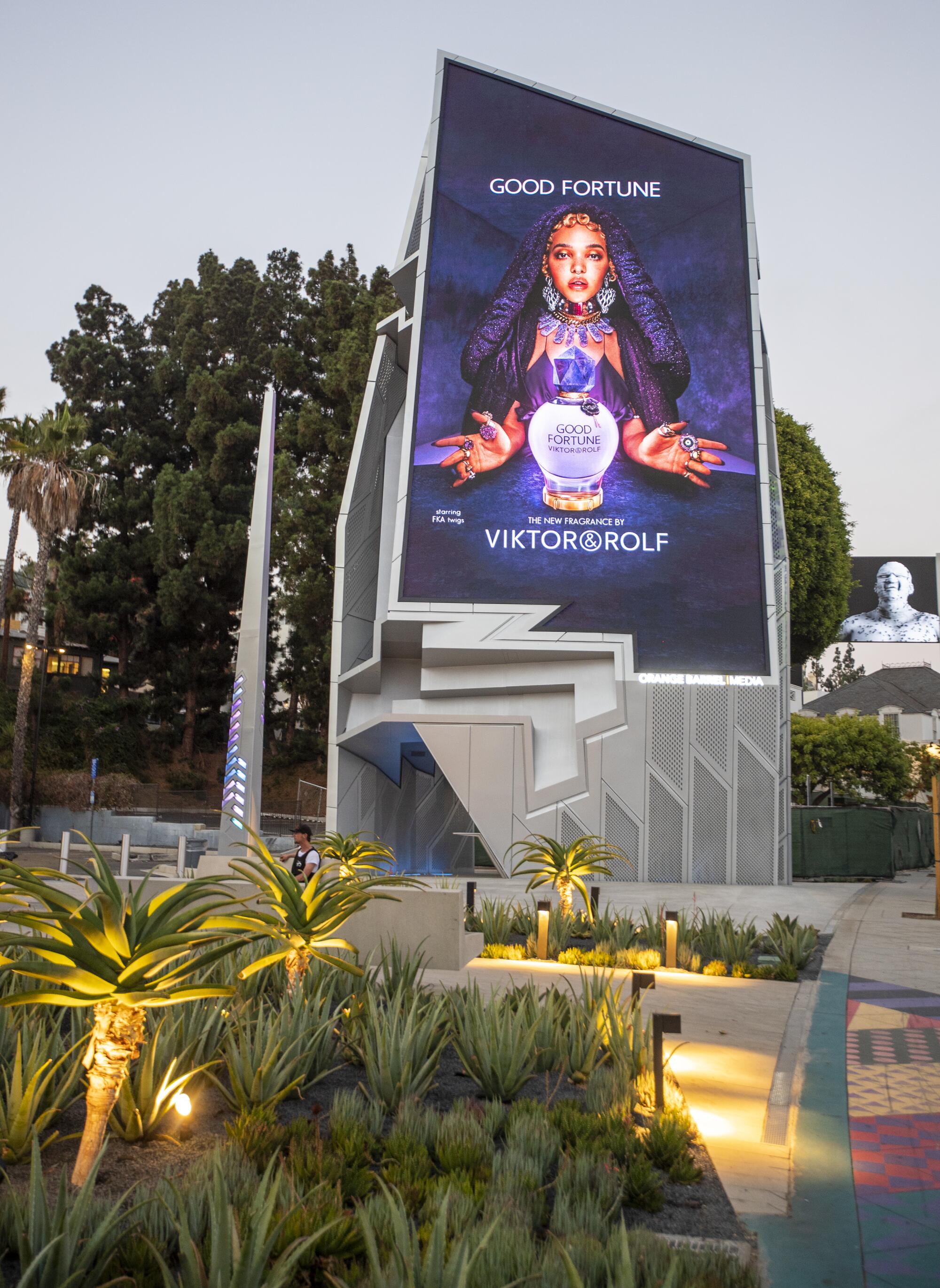 A view of the irregularly shaped Sunset Spectacular billboard featuring a digital ad for Viktor & Rolf.