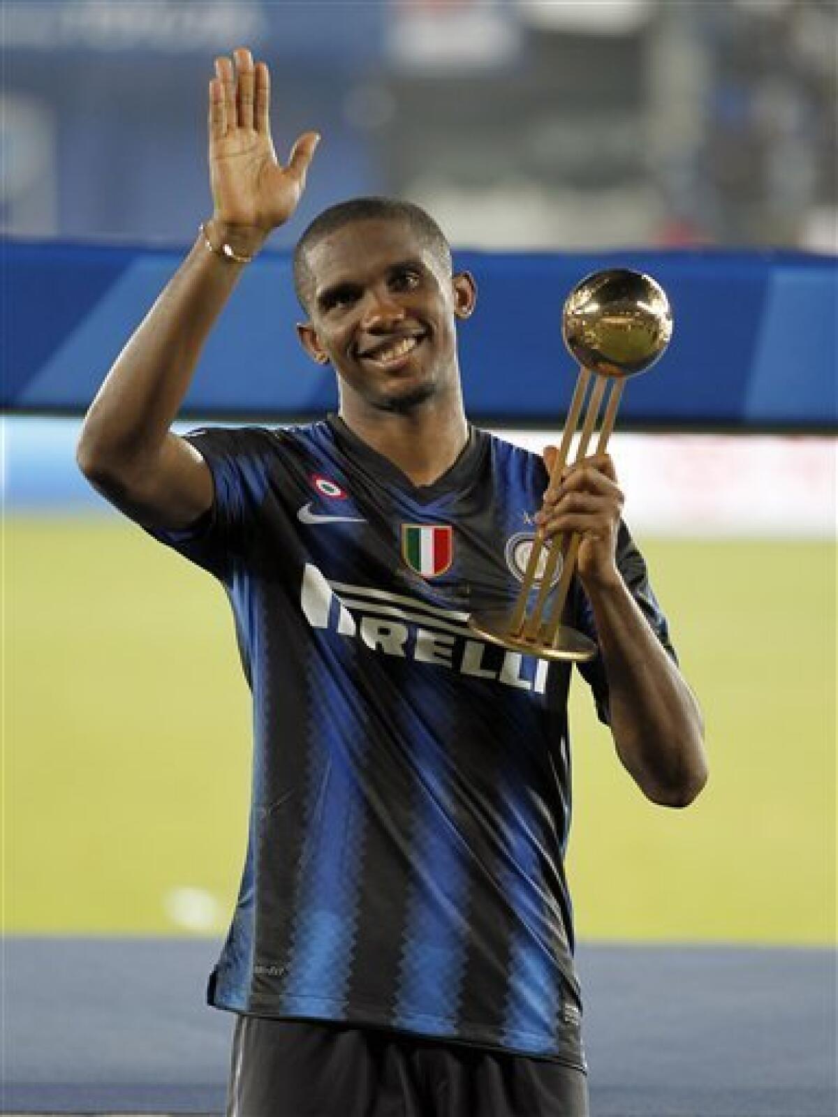 Inter Milan's Samuel Eto'o poses with his personal trophy following the Club World Cup final soccer match against TP Mazembe at Zayed sport city in Abu Dhabi, United Arab Emirates, Saturday, Dec. 18, 2010. (AP Photo/Hassan Ammar)
