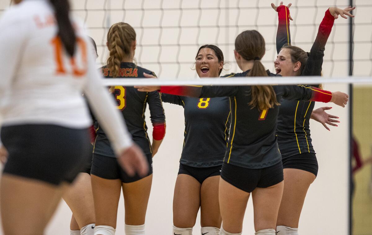Estancia players celebrate a point during a volleyball match against Los Amigos on Thursday.
