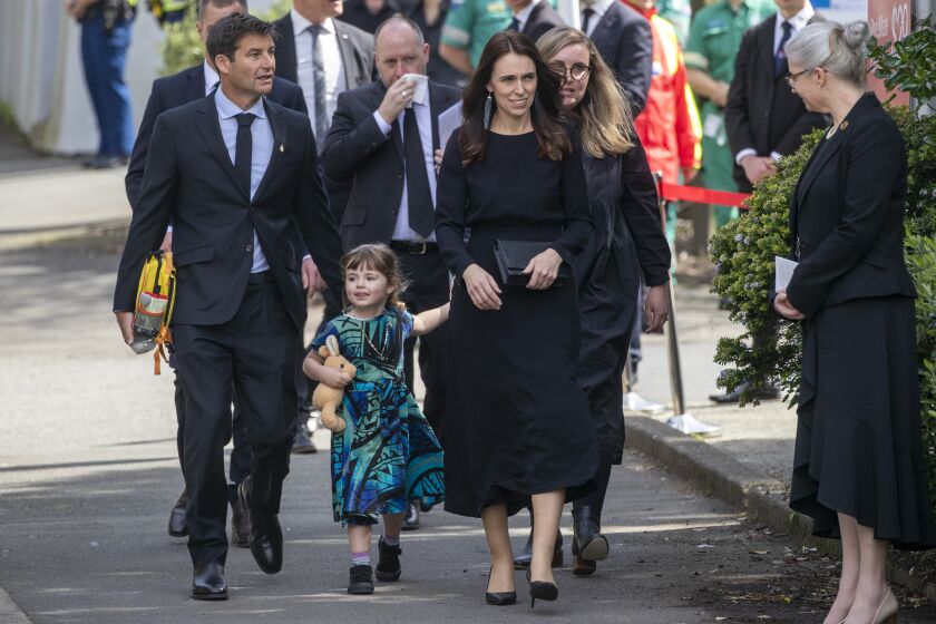 New Zealand Prime Minister Jacinda Ardern arrives with her husband Clarke Gayford and daughter Neve for the Queen's State Memorial Service at the Cathedral of St Paul in Wellington, New Zealand, Monday, Sept. 26, 2022. New Zealand on Monday commemorated Queen Elizabeth II with a public holiday, a minute of silence and an official memorial service. (Mark Mitchell/New Zealand Herald via AP)