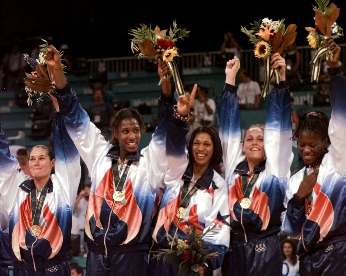U.S. women's basketball team members wear their gold medals during ceremonies at the Centennial Summer Olympic Games.