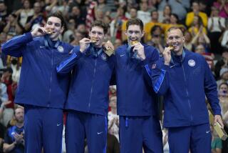 The U.S. United States men's 4x100 meter freestyle relay team celebrates on the podium after winning gold medals