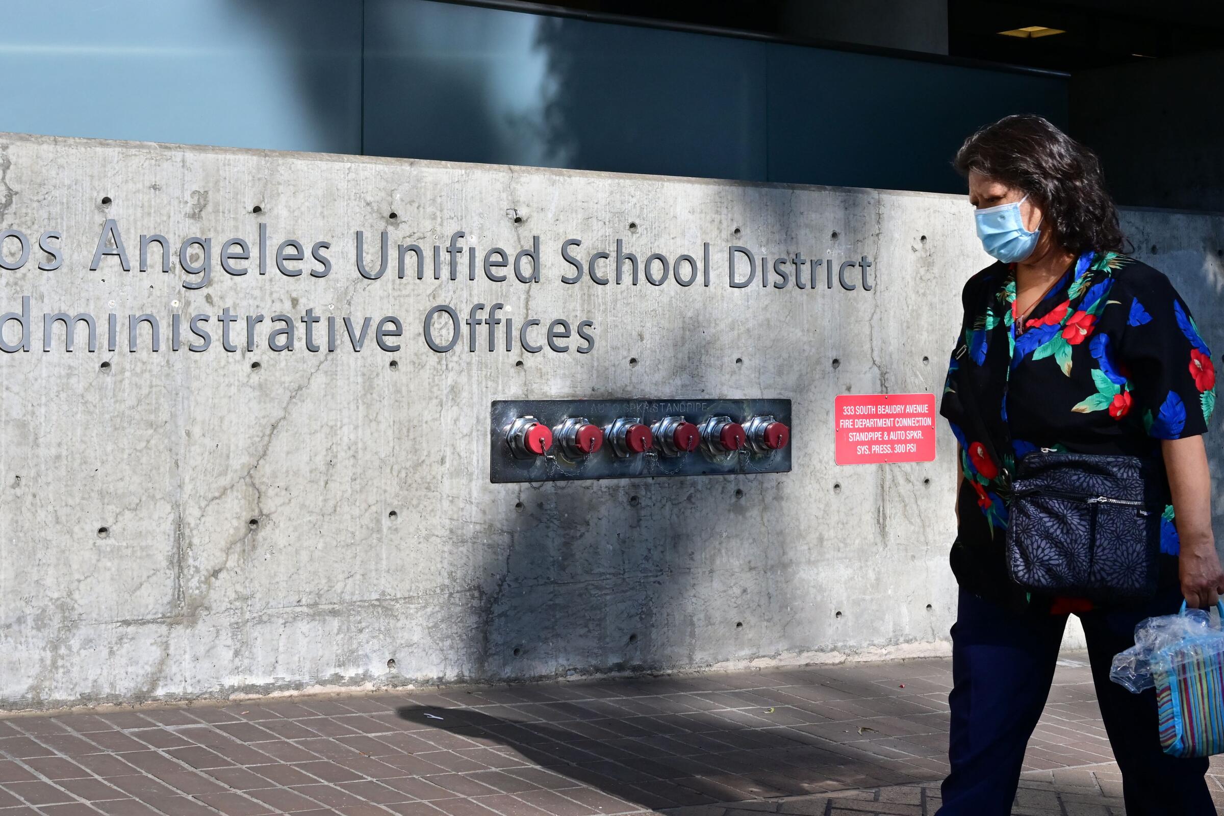 A person walking by L.A. Unified headquarters