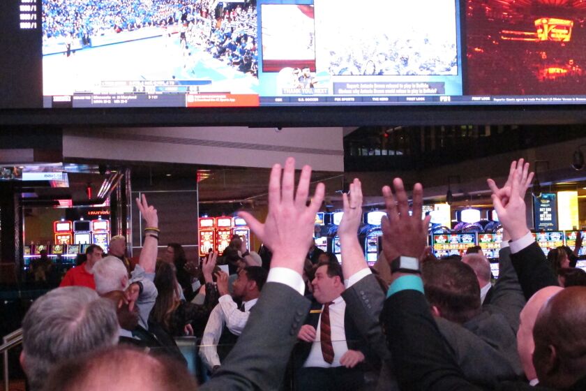 Fans watch college basketball in the sports betting facility at the Tropicana casino in Atlantic City, N.J. on March 8, 2019.