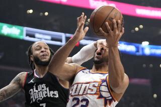 Suns guard Eric Gordon shoots as Clippers guard Amir Coffey defends in the first half.